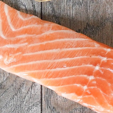 Raw salmon fillet on a wooden surface