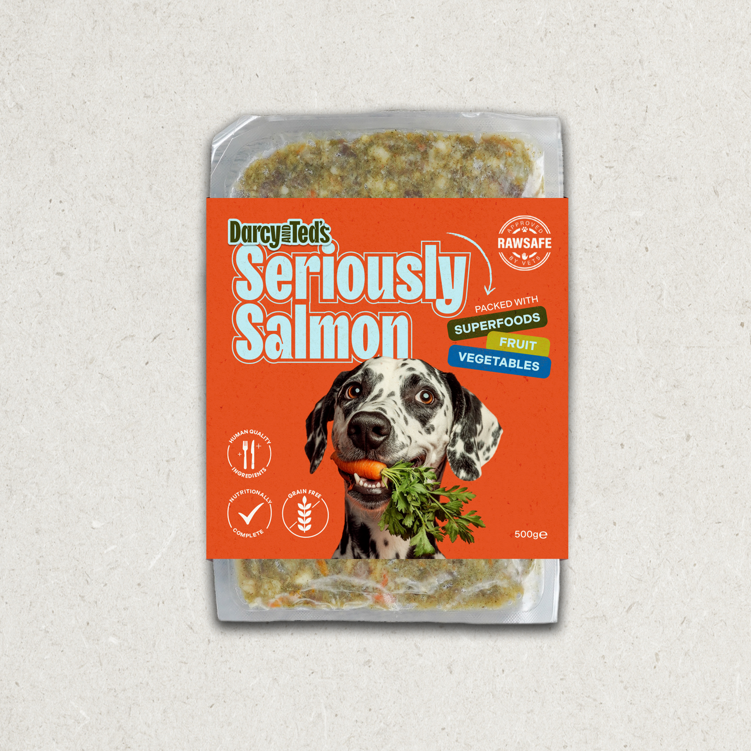 Darcy and Teds Seriously Salmon meal package with a dog holding a carrot on an orange background