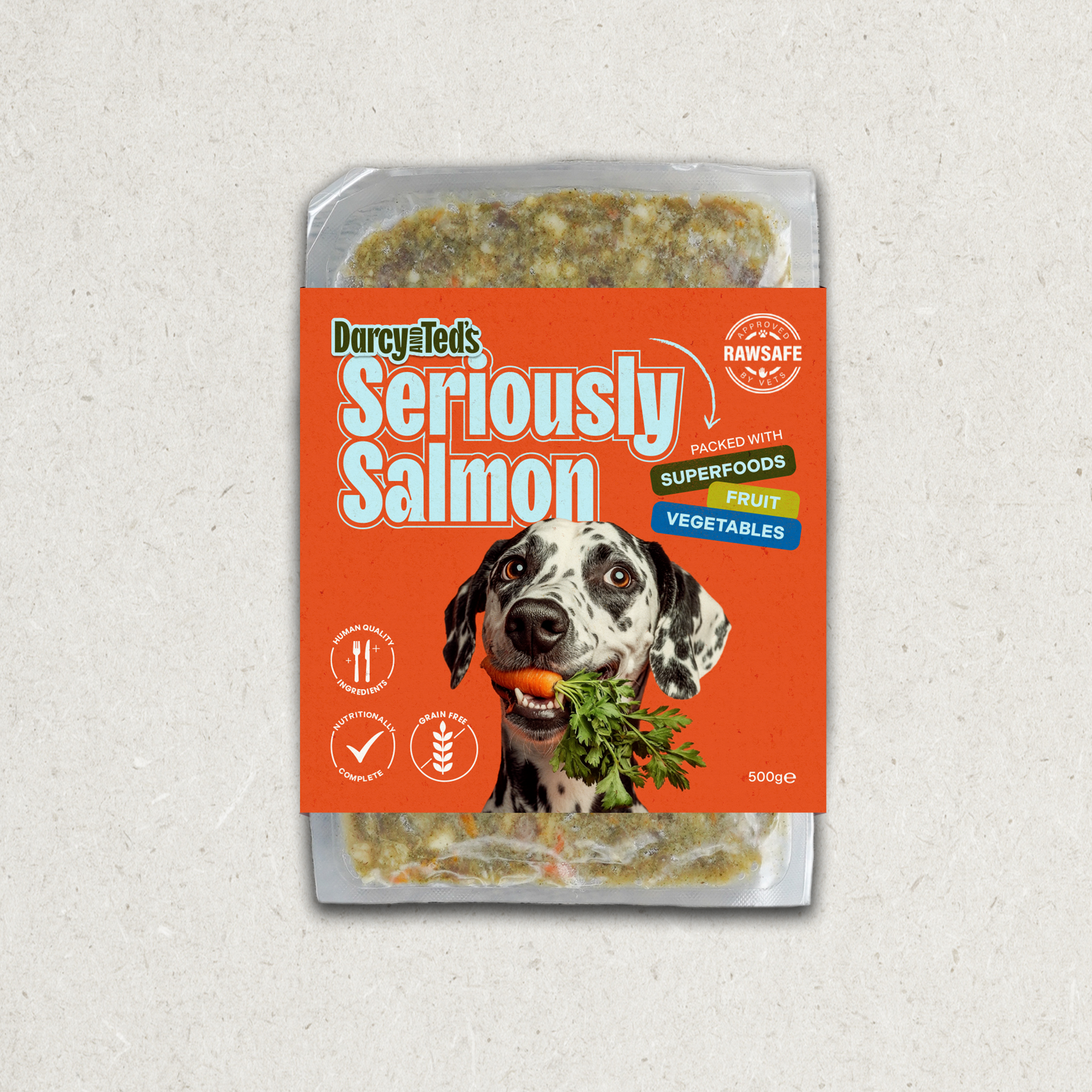 Darcy and Teds Seriously Salmon meal package with a dog holding a carrot on an orange background